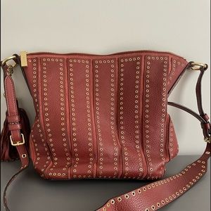 Leather shoulder handbag brown/red with gold grommets. Medium size 14”x10.74x4.5